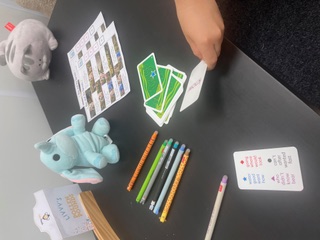 Phonics word cards, coloured pens and learning aids laid out on a table for a session